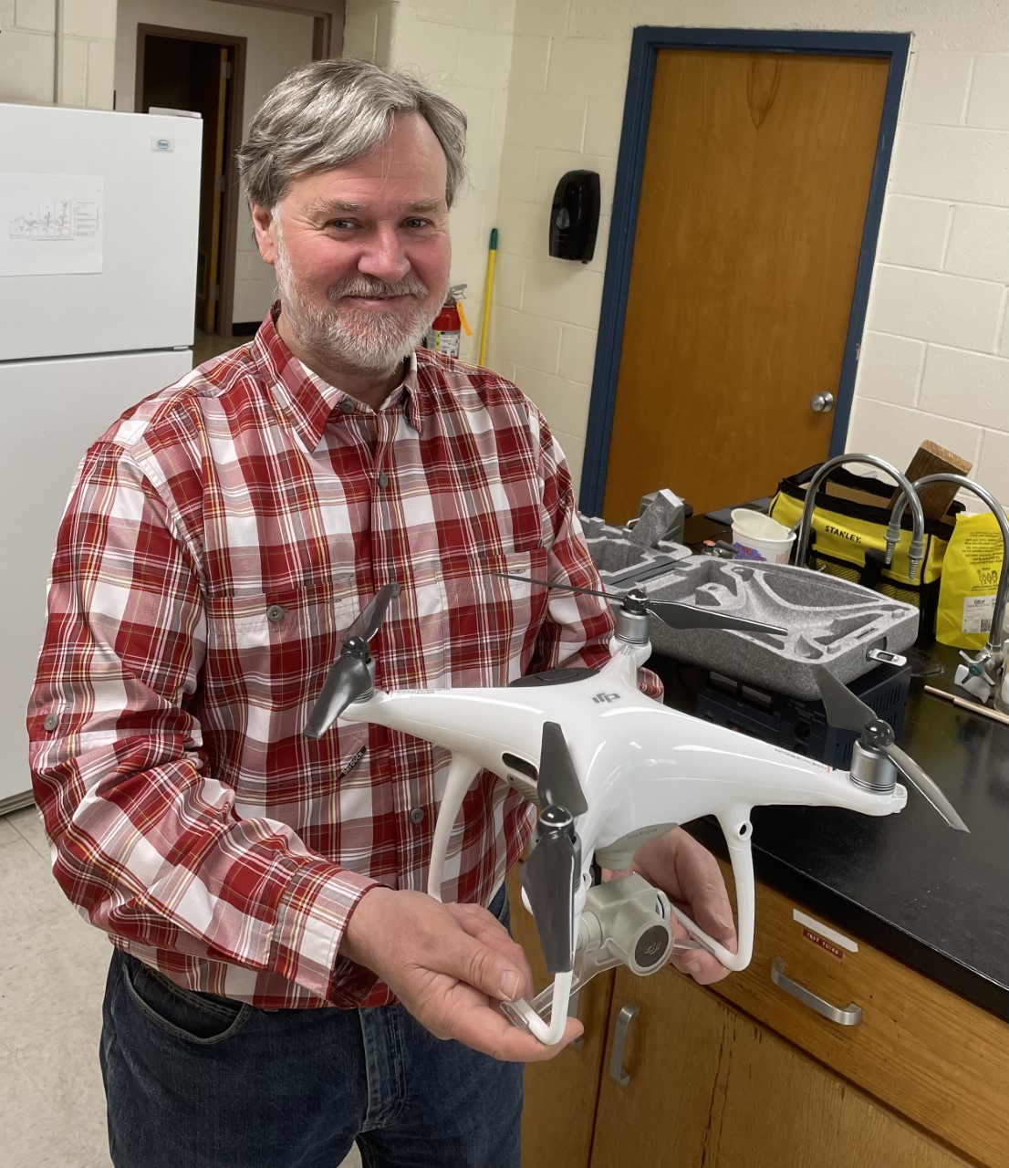 Thomas Wassmer, Professor of Biology and grant project leader holding a drone.
