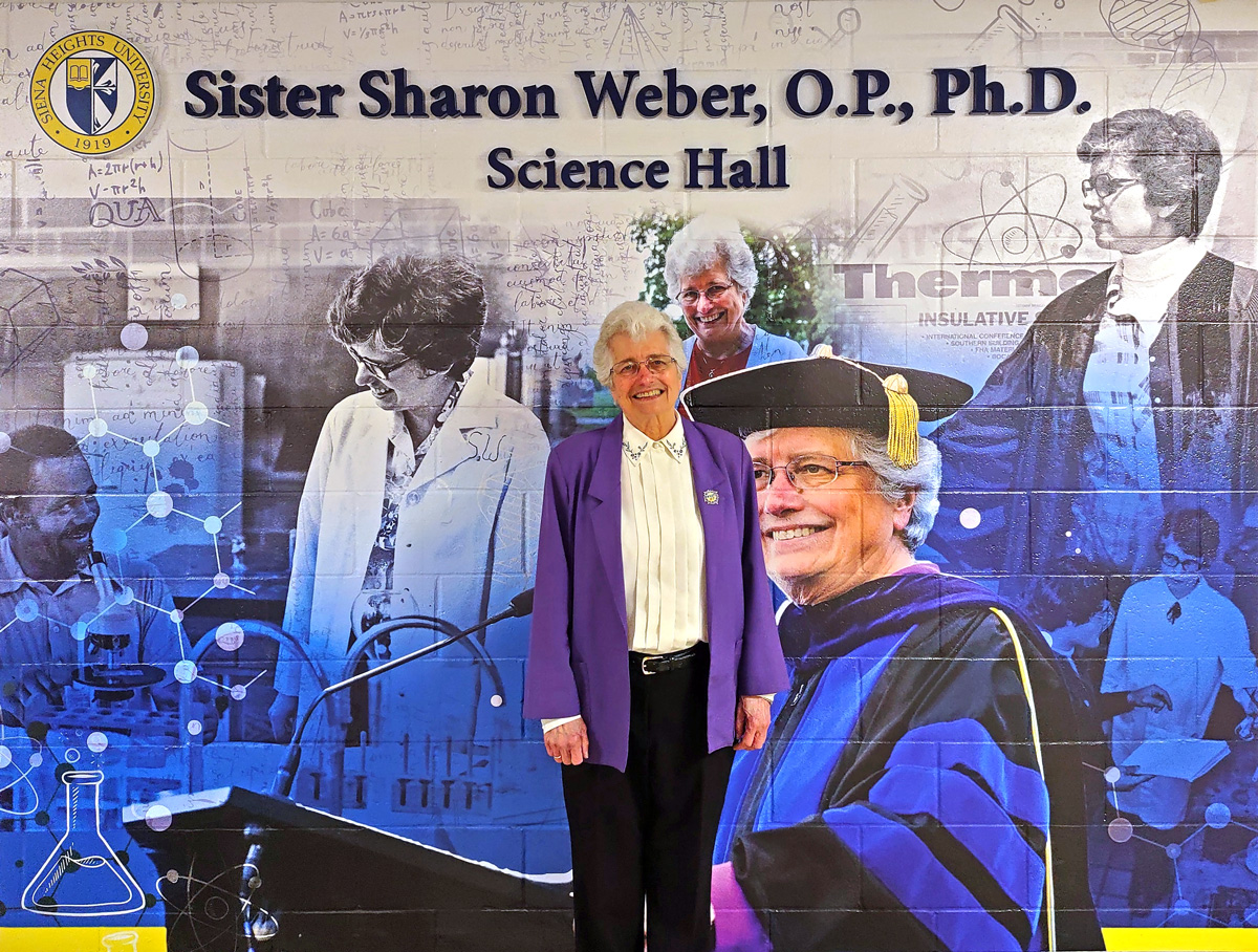 Sister Sharon stands in front of the Science building mural.